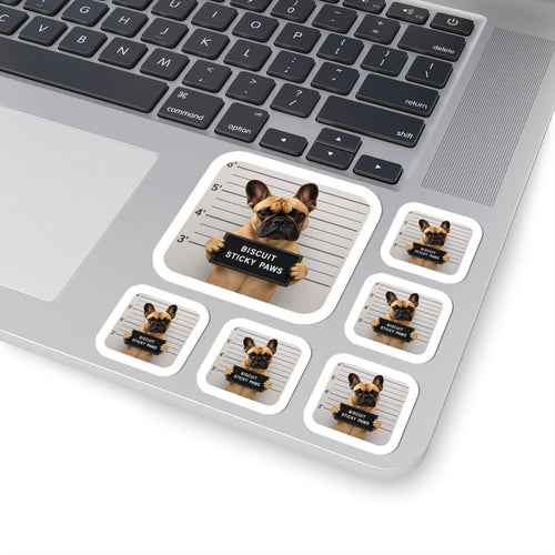 A French bulldog's Most Wanted mugshot, charged with 'Sticky paws', on the sticker sheet (mockup, example portrait — not a photo of a real print)